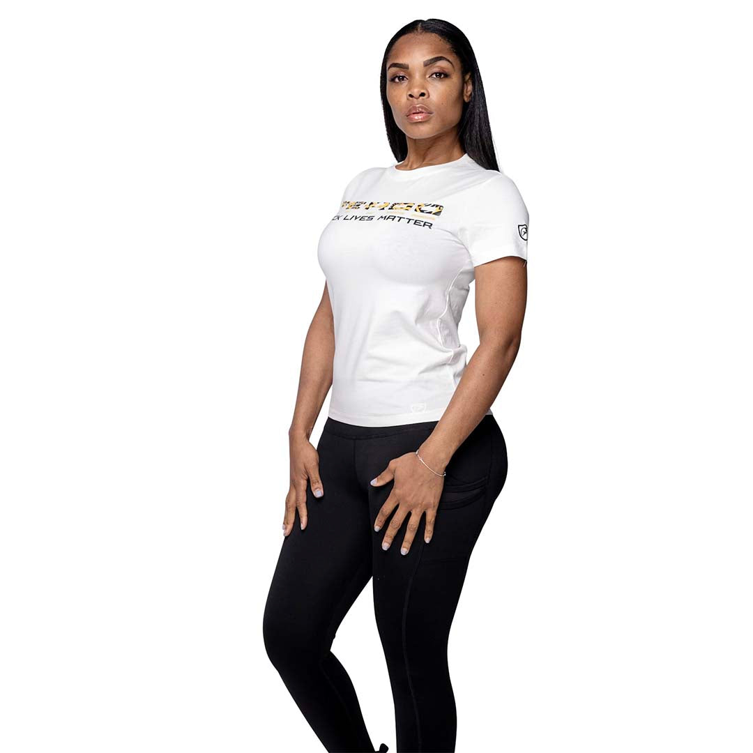 Woman in white "Miami T-Shirt" and black leggings posing.
