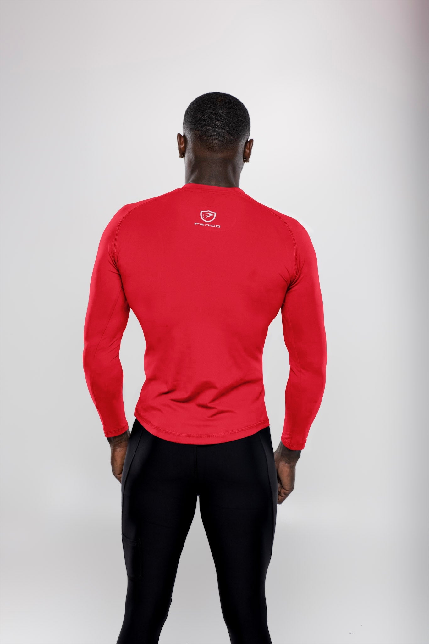 Back view of man wearing red long sleeve athletic shirt and black leggings