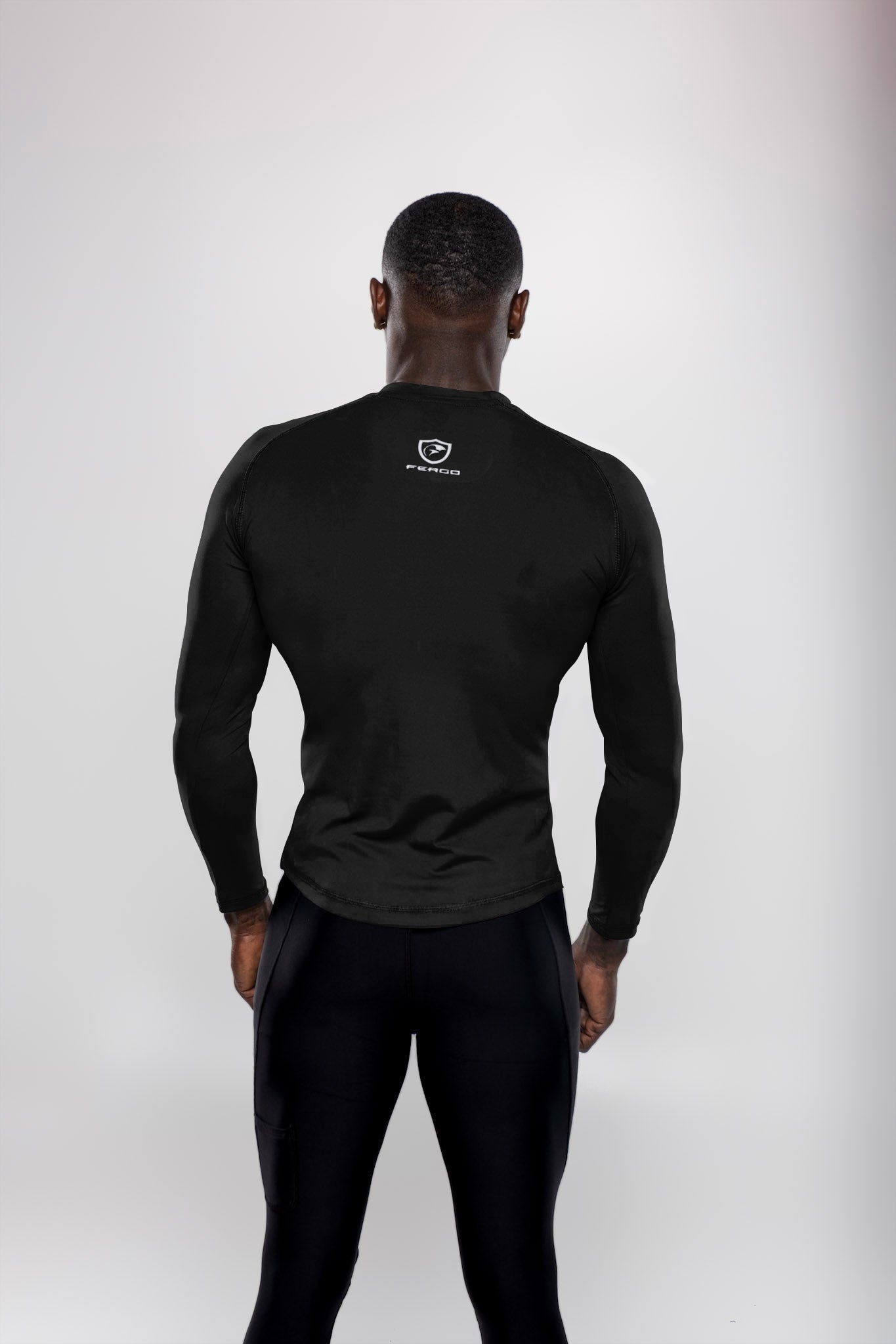 Back view of man wearing Black long sleeve athletic shirt and black leggings