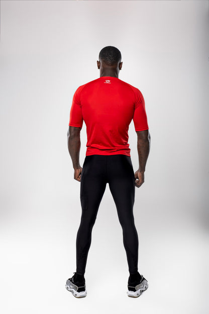 Back view of male model wearing red Cool-Dry Fit 3/4 sleeve mock neck athletic shirt and black leggings.