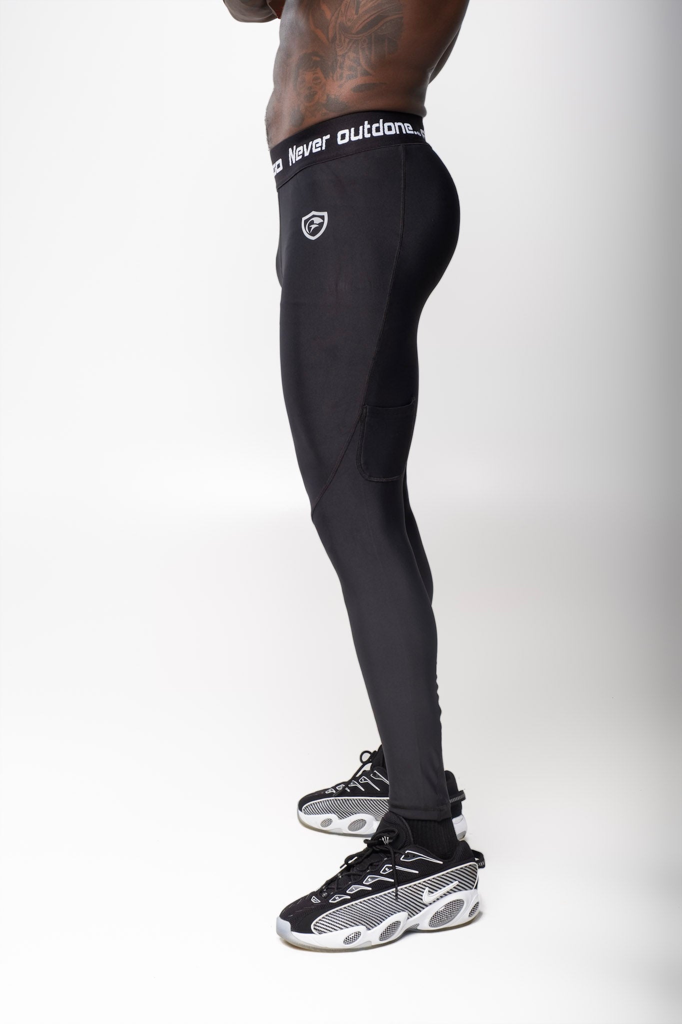 Back view of a man wearing black Men Long Tights showing a fitted athletic style for workouts.
