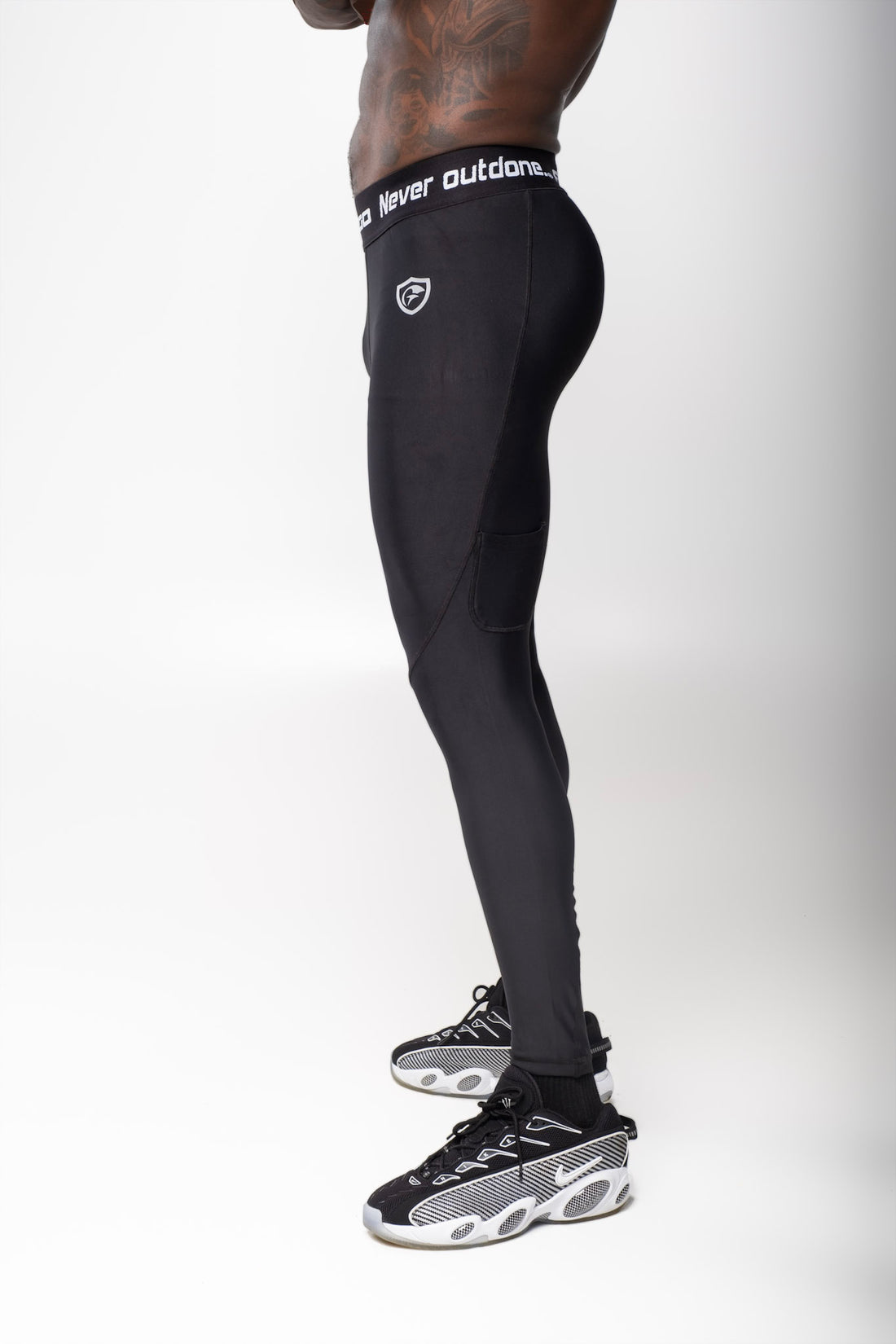Back view of a man wearing black Men Long Tights showing a fitted athletic style for workouts.
